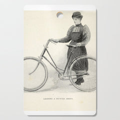 "Leading a Bicycle About" from "Bicycling for Ladies" by Maria E. Ward, 1896 Cutting Board