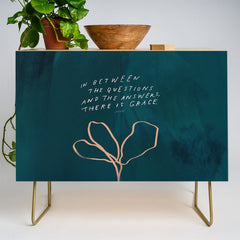 "In Between The Questions And The Answers, There Is Grace." Credenza