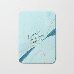 "Here's To Being Free." Bath Mat