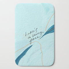"Here's To Being Free." Bath Mat