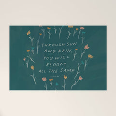 "Through Sun And Rain, You Will Bloom All The Same." Welcome Mat