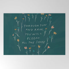 "Through Sun And Rain, You Will Bloom All The Same." Welcome Mat
