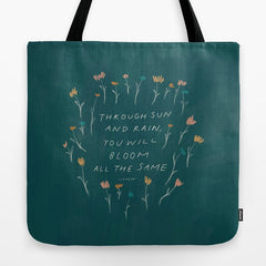 "Through Sun And Rain, You Will Bloom All The Same." Tote Bag