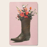 A Cowboy Boot With Spring Bouquet Cutting Board