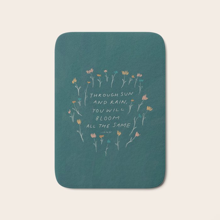 "Through Sun And Rain, You Will Bloom All The Same." Bath Mat