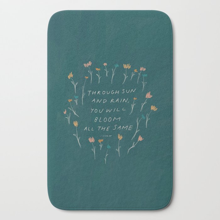 "Through Sun And Rain, You Will Bloom All The Same." Bath Mat