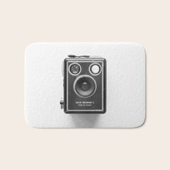 A Kodak Brownie analog vintage camera on a white background  Retro photography in black and white Bath Mat