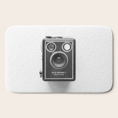 A Kodak Brownie analog vintage camera on a white background  Retro photography in black and white Bath Mat