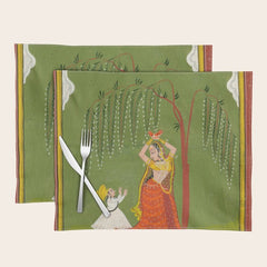 A female attendant is standing in tribhanga pose under a tree. A small child vies for her attention. Placemat