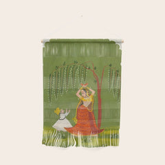A female attendant is standing in tribhanga pose under a tree. A small child vies for her attention. Wall Hanging