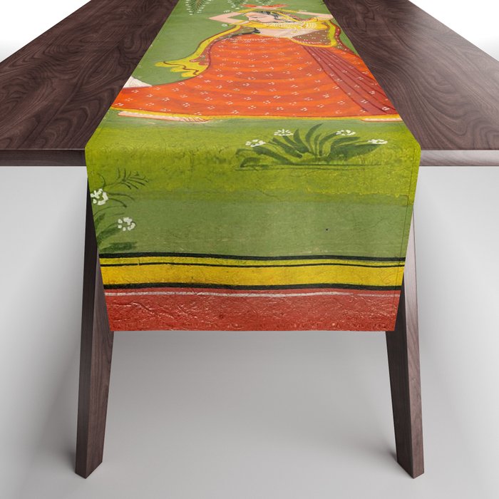 A female attendant is standing in tribhanga pose under a tree. A small child vies for her attention. Table Runner