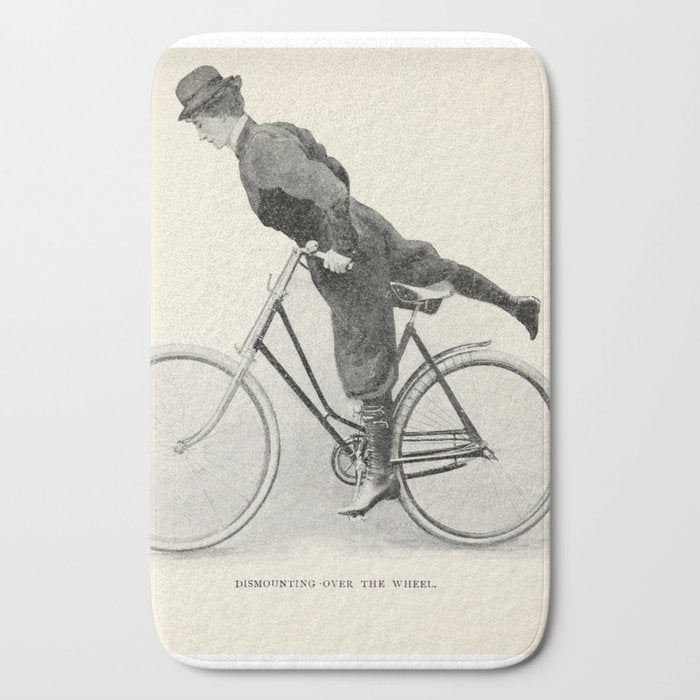 "Dismounting Over the Wheel" from "Bicycling for Ladies" by Maria E. Ward, 1896 Bath Mat