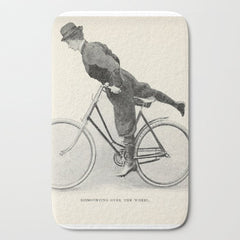 "Dismounting Over the Wheel" from "Bicycling for Ladies" by Maria E. Ward, 1896 Bath Mat
