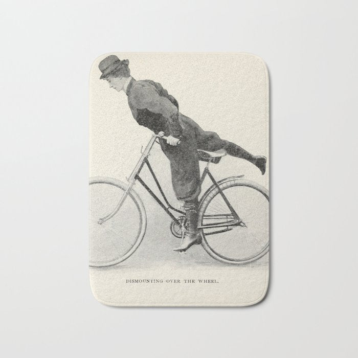 "Dismounting Over the Wheel" from "Bicycling for Ladies" by Maria E. Ward, 1896 Bath Mat