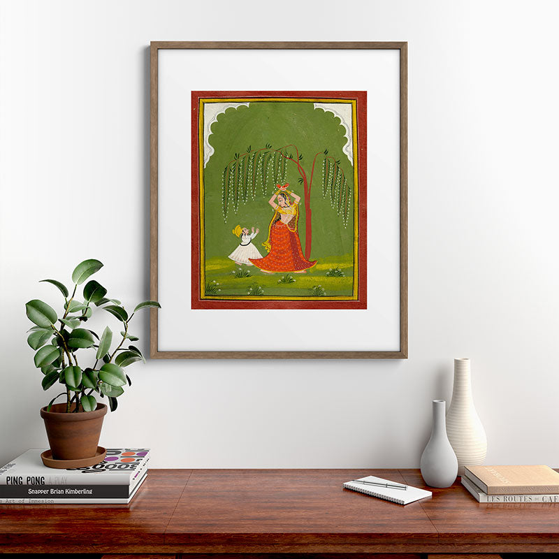 A female attendant is standing in tribhanga pose under a tree. A small child vies for her attention. Framed Art Print