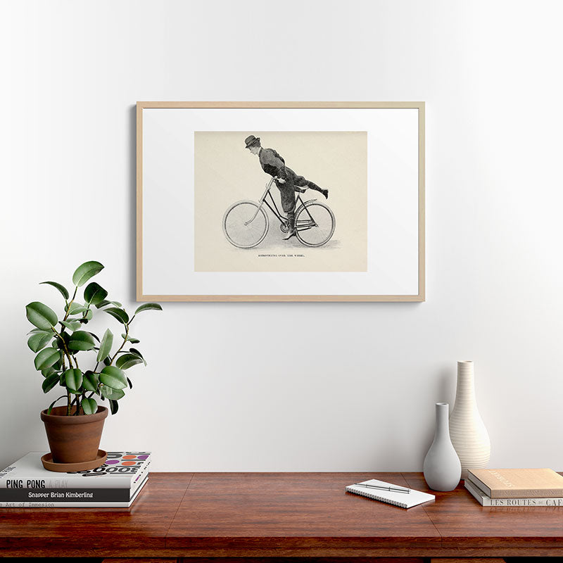 "Dismounting Over the Wheel" from "Bicycling for Ladies" by Maria E. Ward, 1896 Framed Art Print
