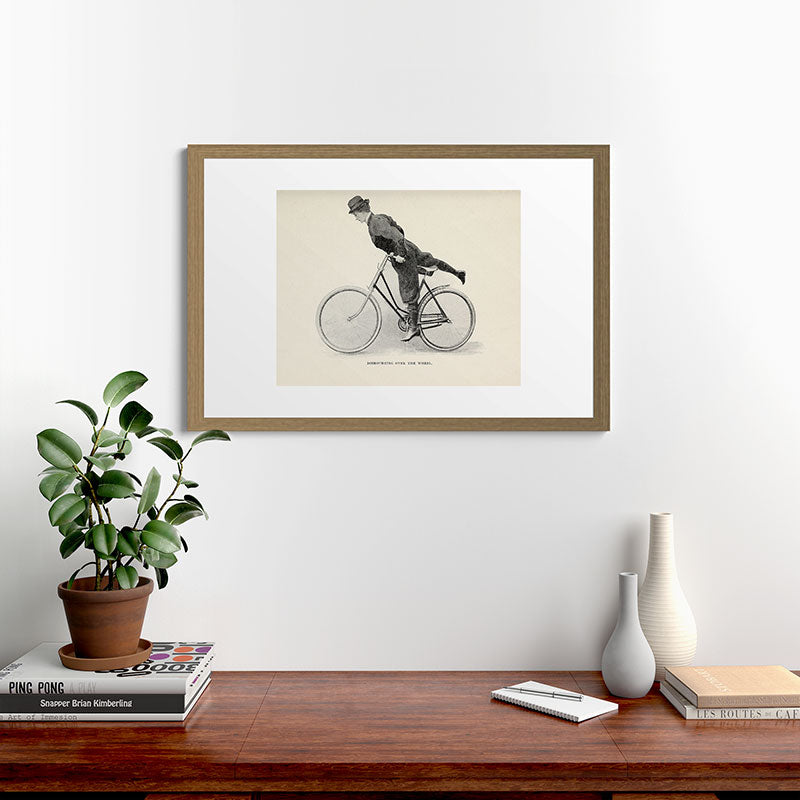"Dismounting Over the Wheel" from "Bicycling for Ladies" by Maria E. Ward, 1896 Framed Art Print