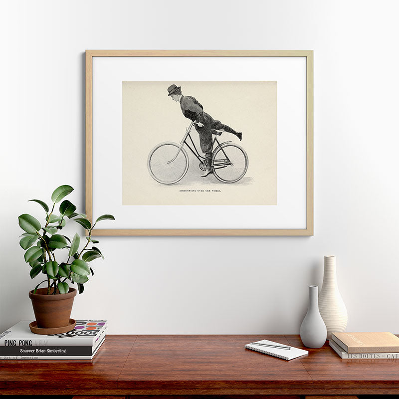 "Dismounting Over the Wheel" from "Bicycling for Ladies" by Maria E. Ward, 1896 Framed Art Print