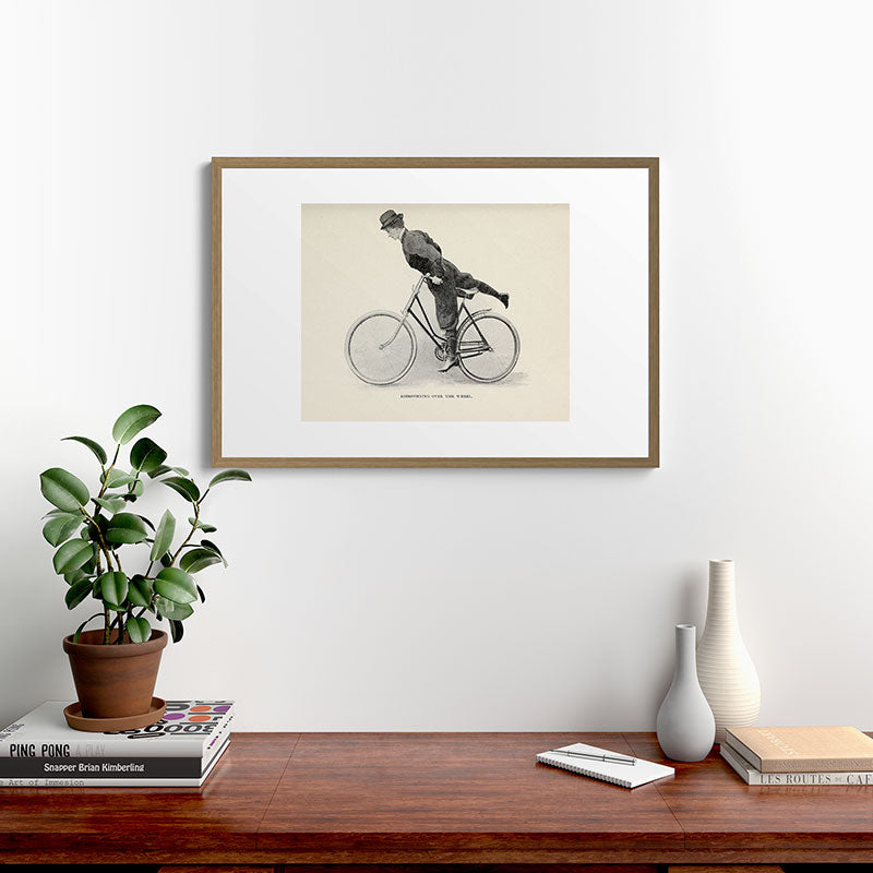 "Dismounting Over the Wheel" from "Bicycling for Ladies" by Maria E. Ward, 1896 Framed Art Print