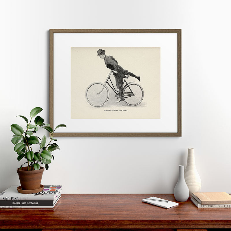 "Dismounting Over the Wheel" from "Bicycling for Ladies" by Maria E. Ward, 1896 Framed Art Print