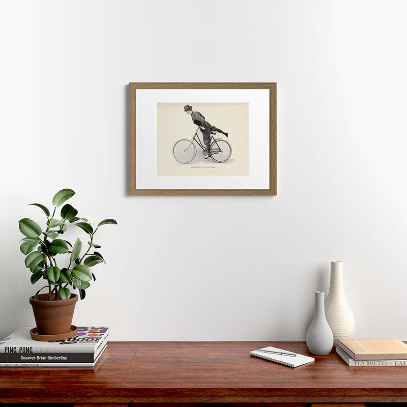 "Dismounting Over the Wheel" from "Bicycling for Ladies" by Maria E. Ward, 1896 Framed Art Print
