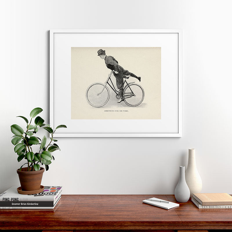 "Dismounting Over the Wheel" from "Bicycling for Ladies" by Maria E. Ward, 1896 Framed Art Print