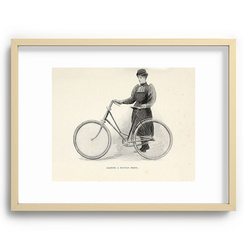 "Leading a Bicycle About" from "Bicycling for Ladies" by Maria E. Ward, 1896 Framed Art Print