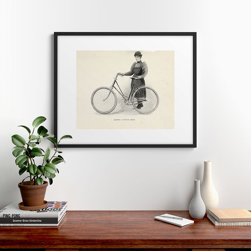 "Leading a Bicycle About" from "Bicycling for Ladies" by Maria E. Ward, 1896 Framed Art Print