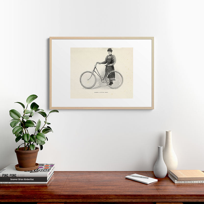 "Leading a Bicycle About" from "Bicycling for Ladies" by Maria E. Ward, 1896 Framed Art Print