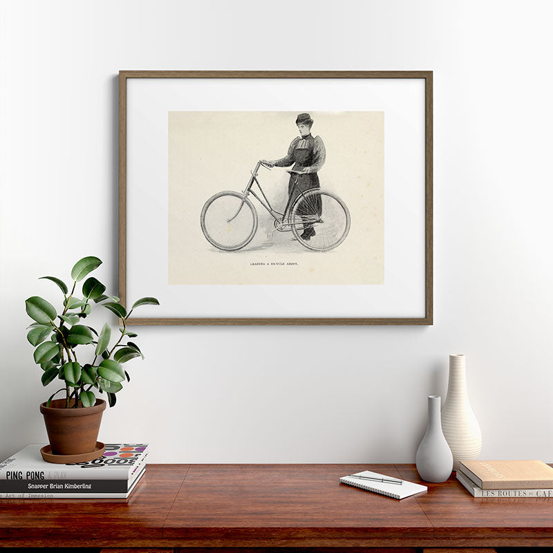 "Leading a Bicycle About" from "Bicycling for Ladies" by Maria E. Ward, 1896 Framed Art Print