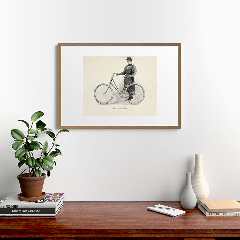 "Leading a Bicycle About" from "Bicycling for Ladies" by Maria E. Ward, 1896 Framed Art Print