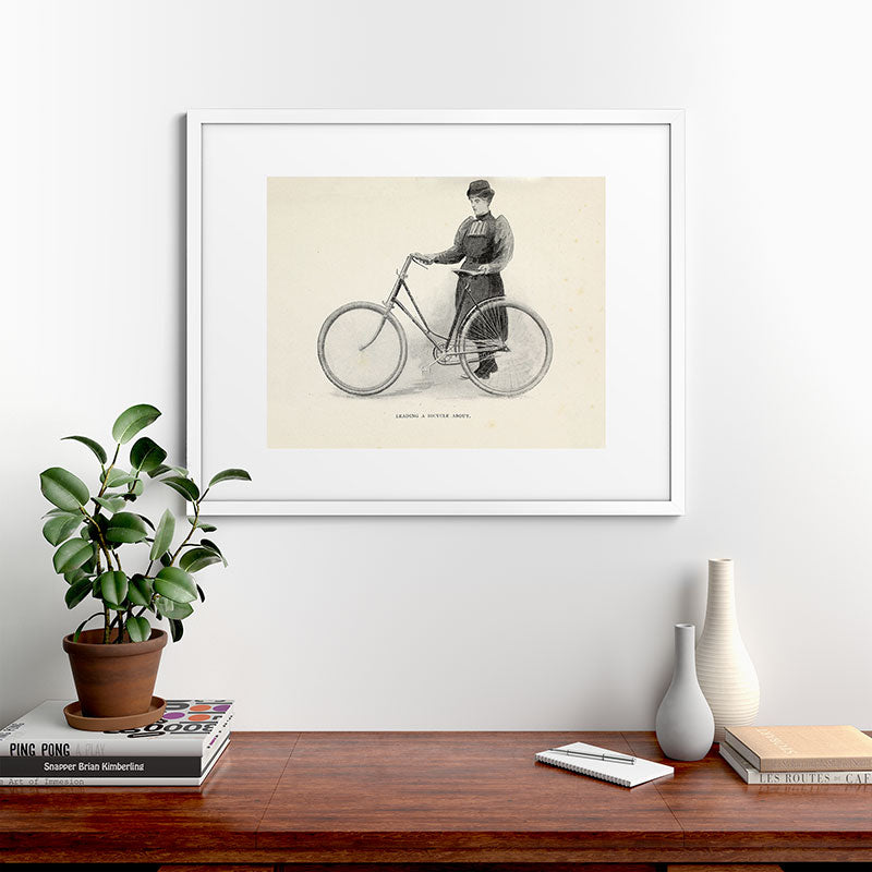 "Leading a Bicycle About" from "Bicycling for Ladies" by Maria E. Ward, 1896 Framed Art Print