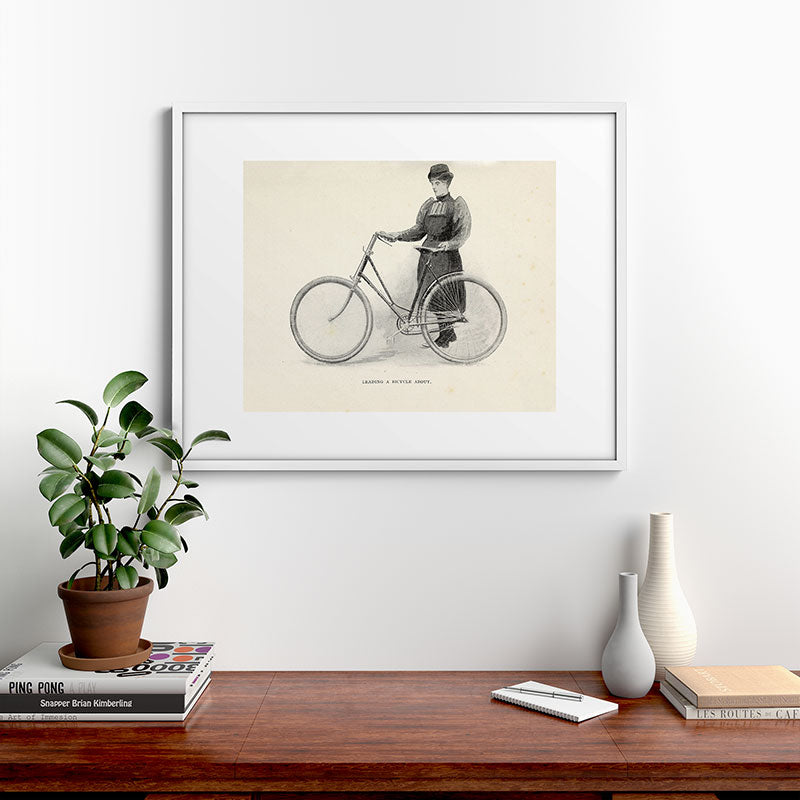 "Leading a Bicycle About" from "Bicycling for Ladies" by Maria E. Ward, 1896 Framed Art Print