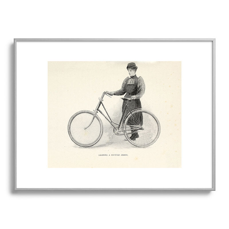 "Leading a Bicycle About" from "Bicycling for Ladies" by Maria E. Ward, 1896 Framed Art Print