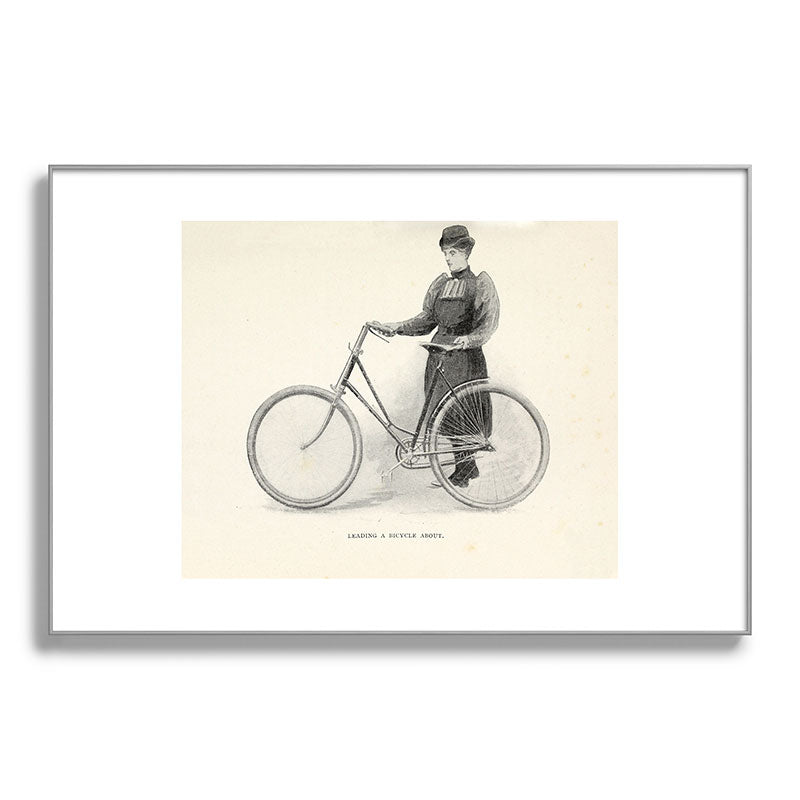 "Leading a Bicycle About" from "Bicycling for Ladies" by Maria E. Ward, 1896 Framed Art Print