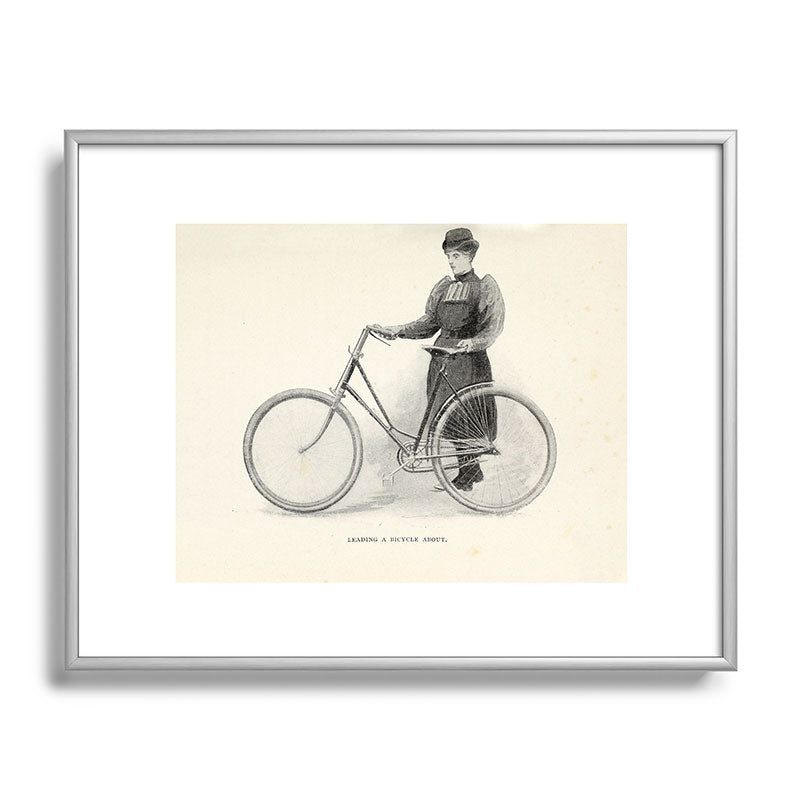 "Leading a Bicycle About" from "Bicycling for Ladies" by Maria E. Ward, 1896 Framed Art Print